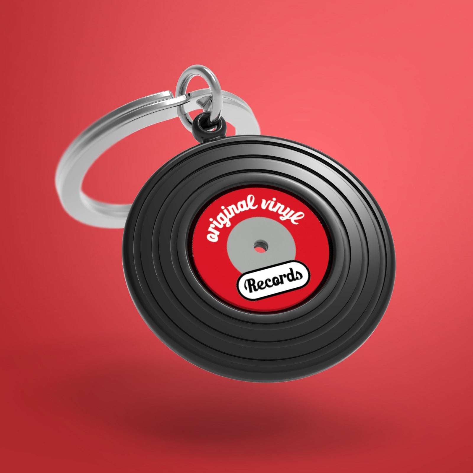 Keychain designed like a vinyl record with 'original vinyl records' text on a red background