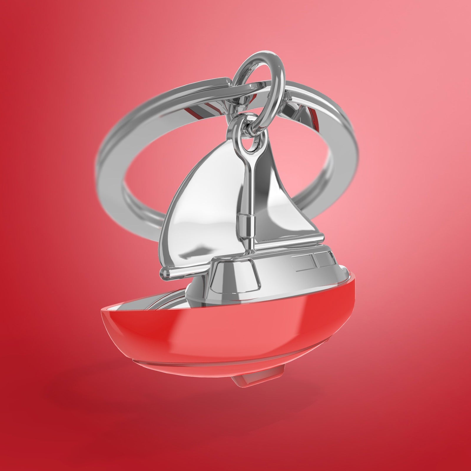 Sailboat keychain with red base and silver sail on a red background