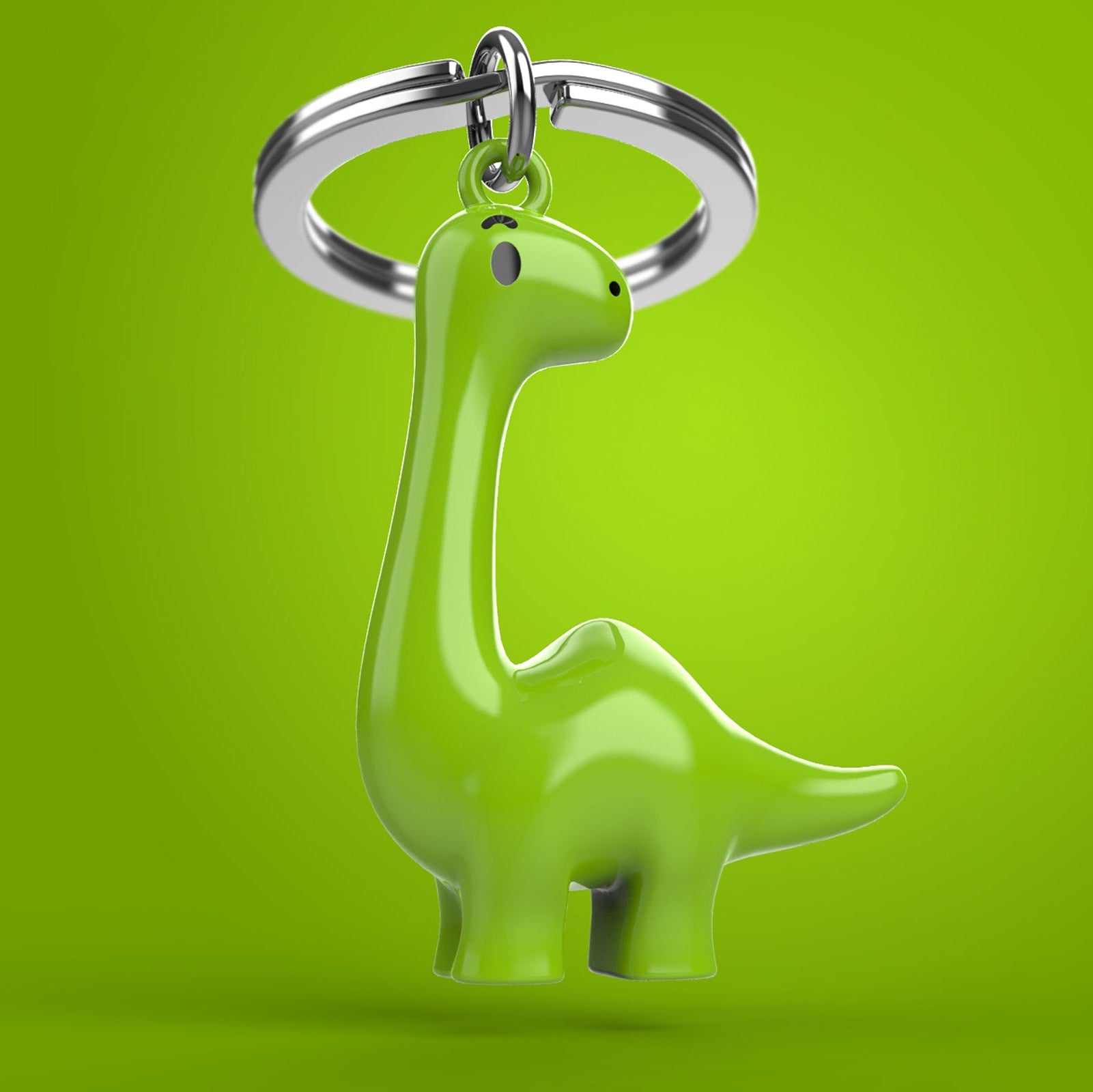 Green dinosaur-shaped keychain on a green background
