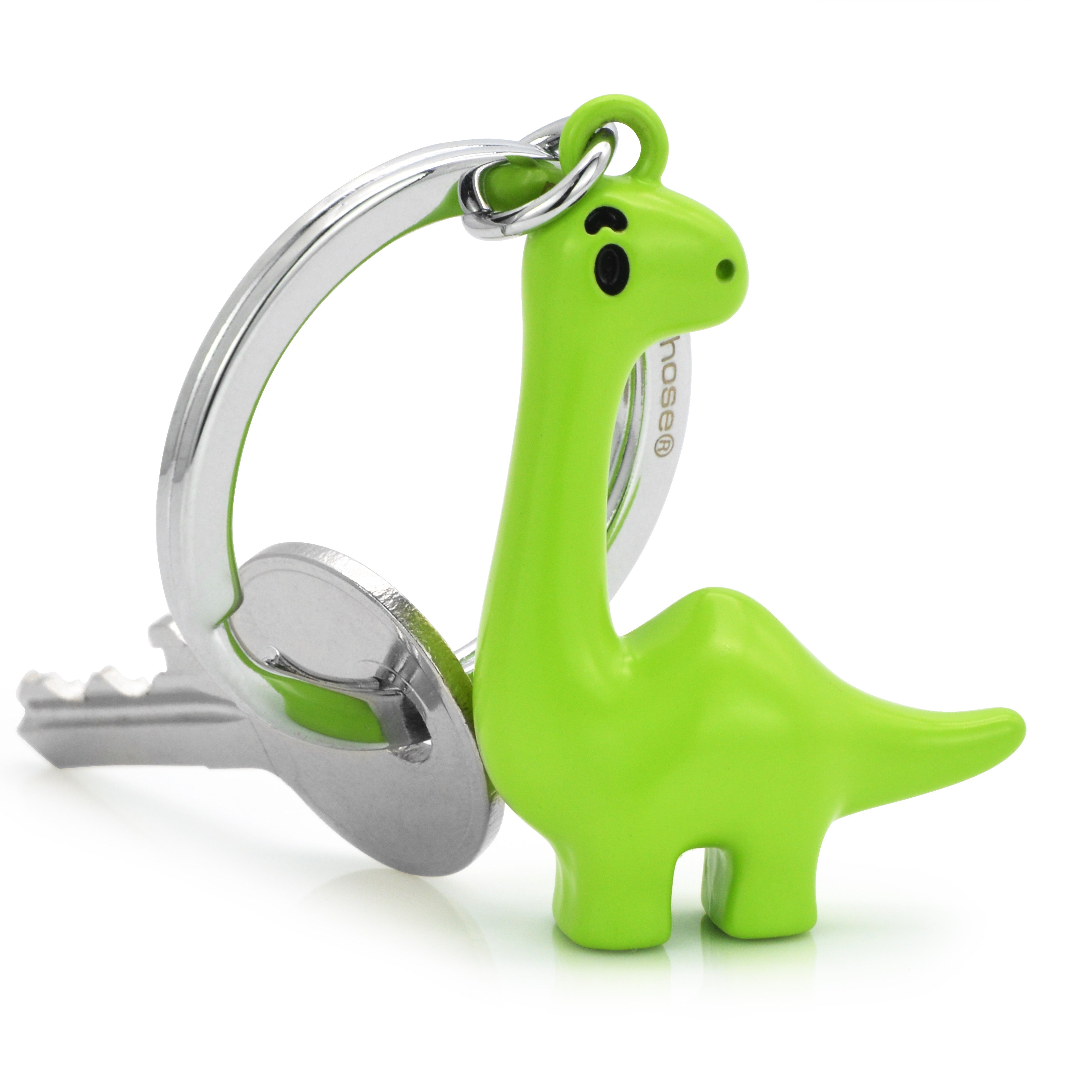 Green dinosaur-shaped keychain attached to a key on a white background